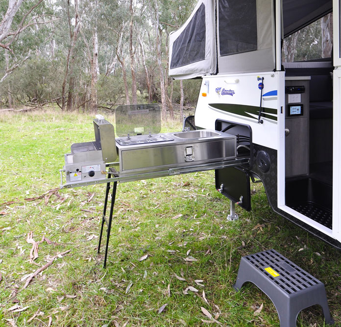 The cooking facilities feature slide-out kitchen storage and stainless steel cabinets plus a BBQ